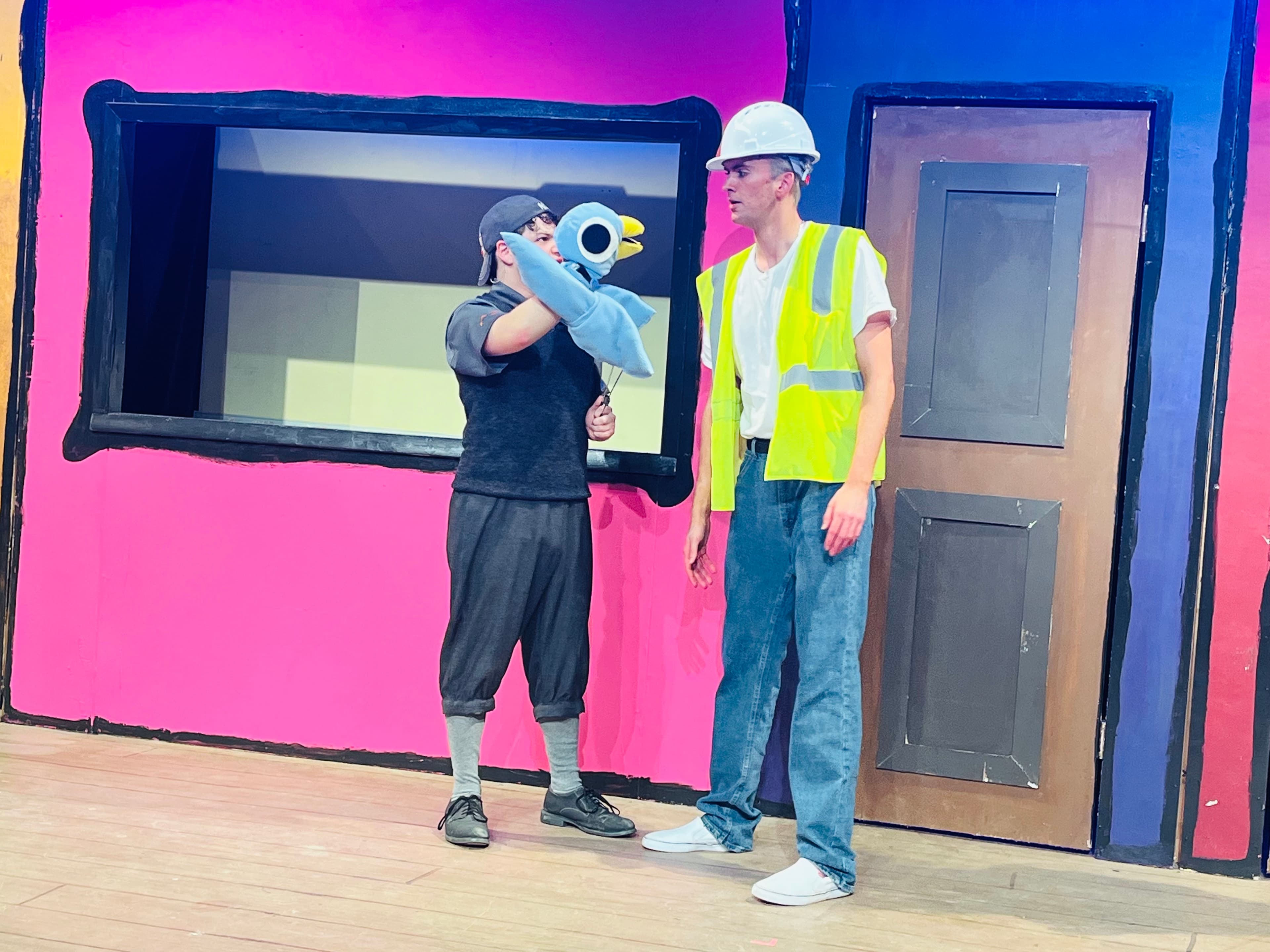 Jacob with Pidgeon puppet, talking to construction worker