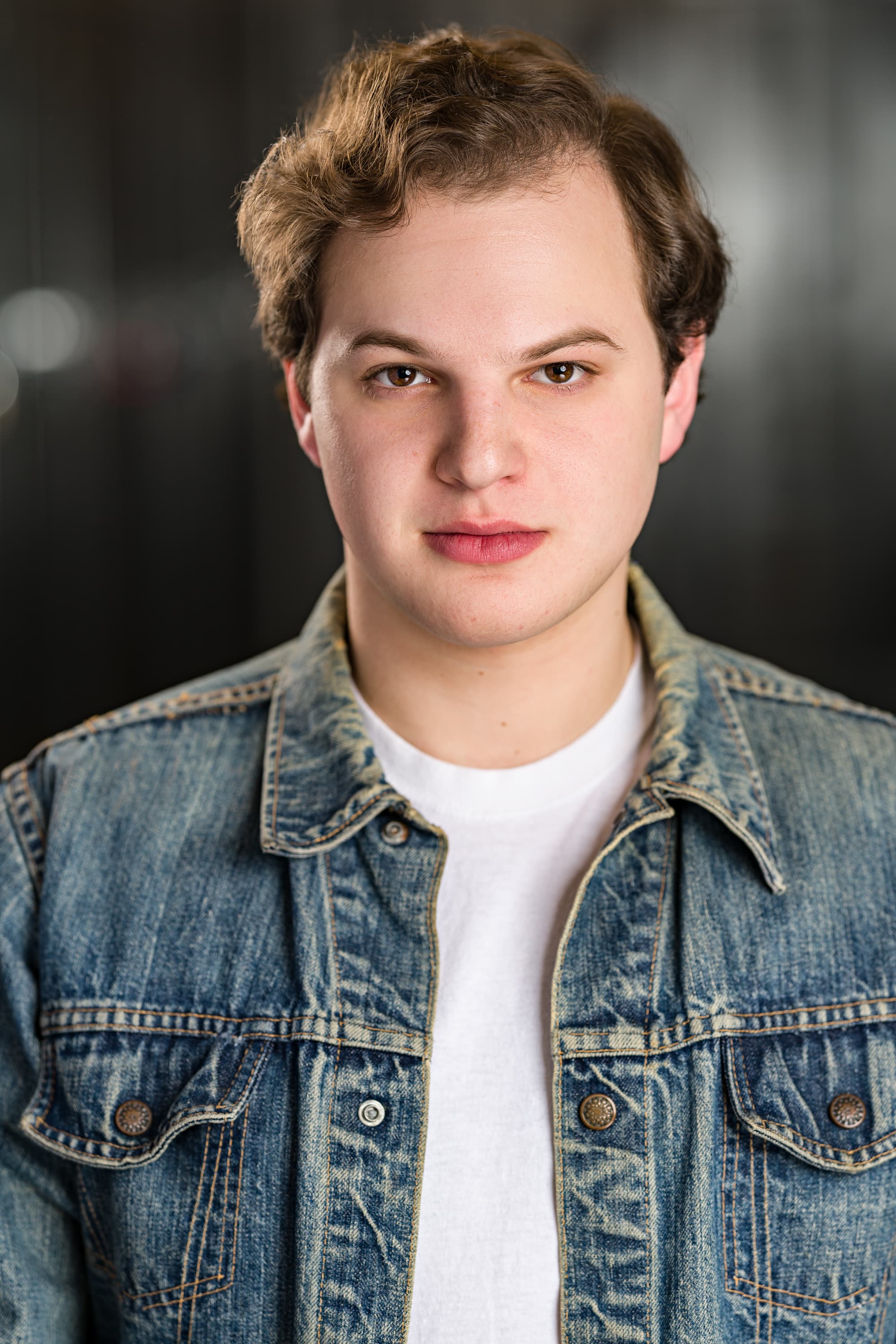 Jacob in denim jacket, looking serious.