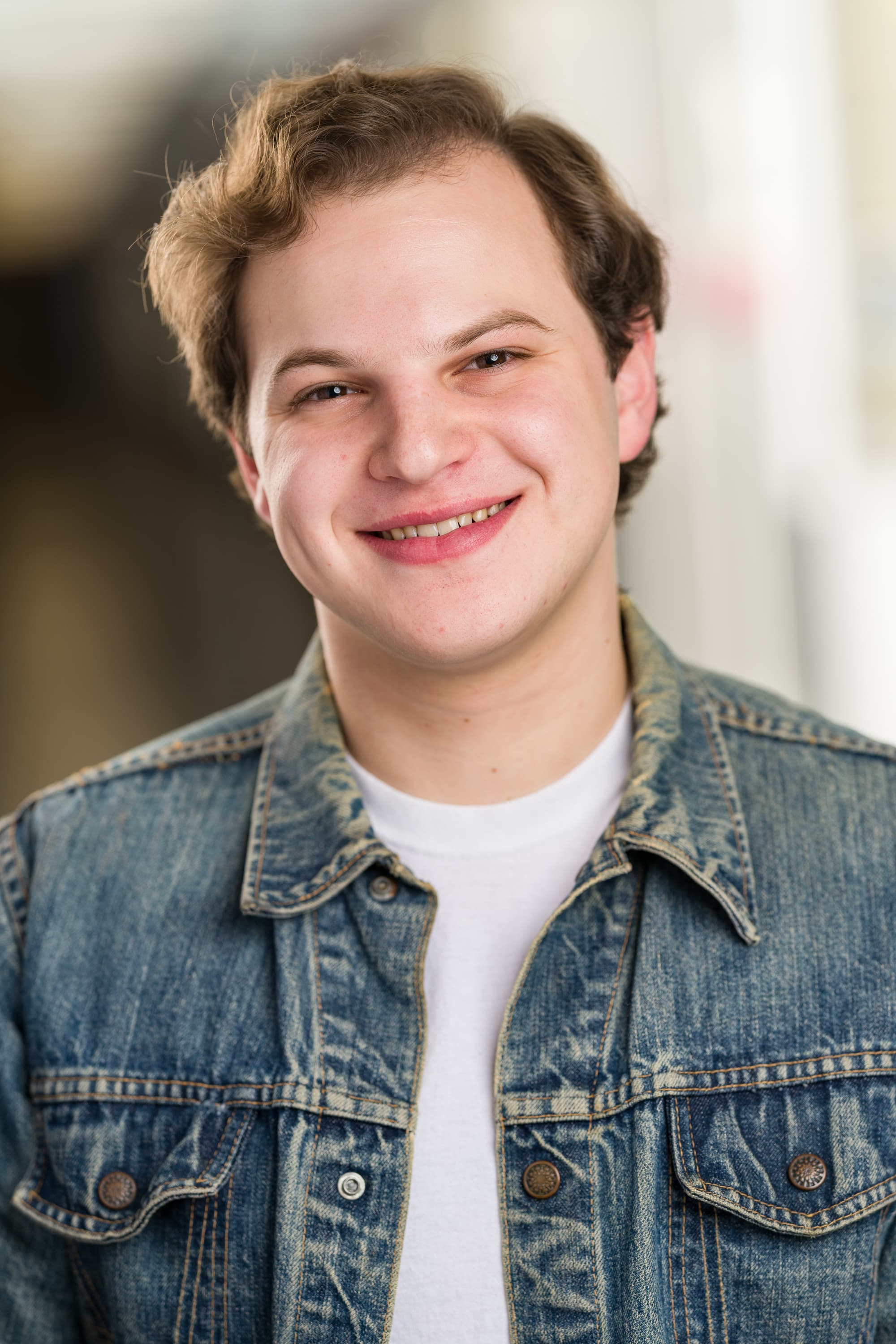 Jacob in denim jacket, kind smile.